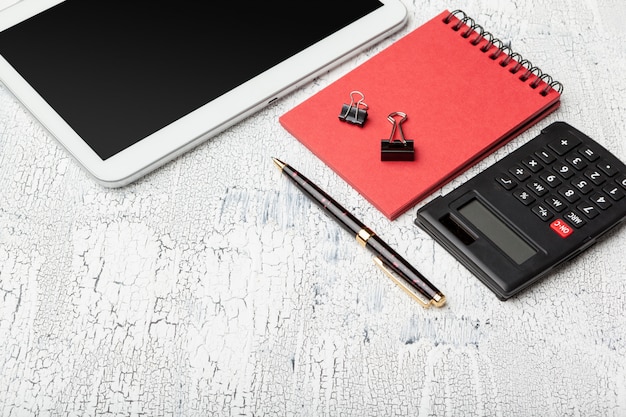 A close-up shot of a calculator, a pen, and a financial document showing graphs and charts, symbolizing financial planning and calculations related to Social Security benefits.