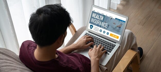 A person using a laptop to compare different loan options. The screen shows various loan terms, interest rates, and repayment schedules.