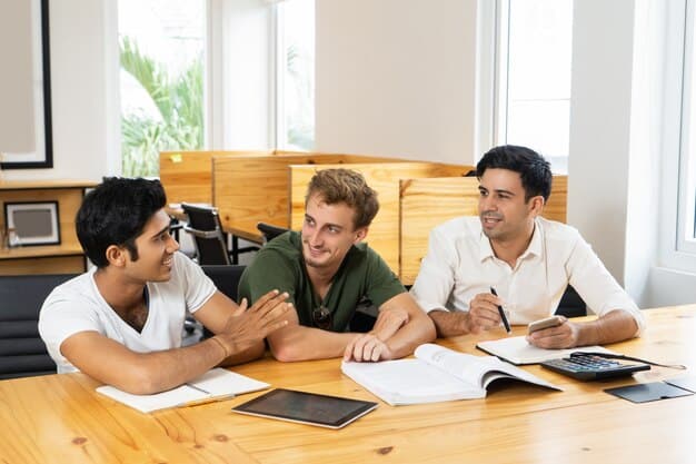 Young adults sitting at a table discussing college loans.