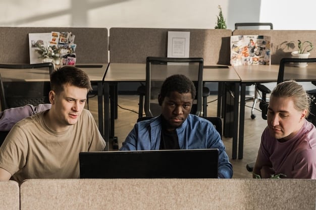 A diverse group of students working together on a project in a brightly lit classroom, with one student using a screen reader on their laptop.