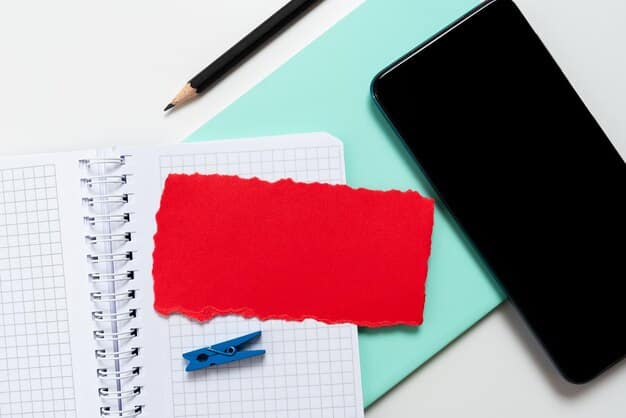 A smartphone displaying an email with a scholarship offer. The email is marked with a red exclamation point and a sense of urgency. The background is a cluttered desk with school supplies.